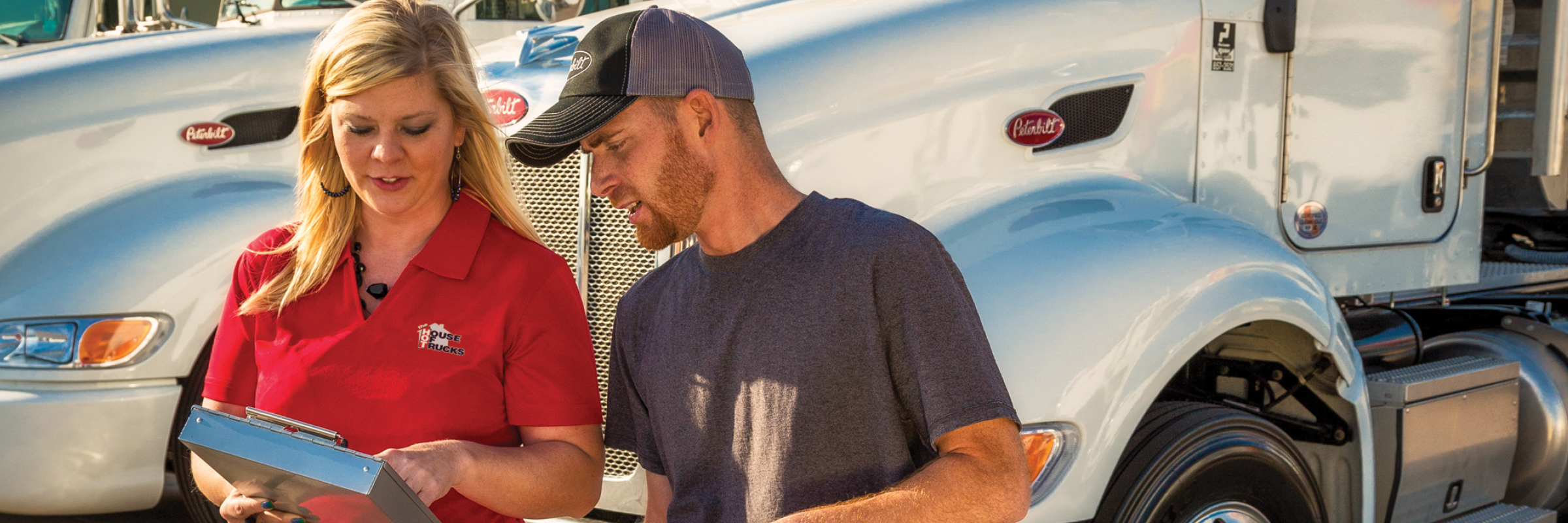 Employee talking to customer next to truck